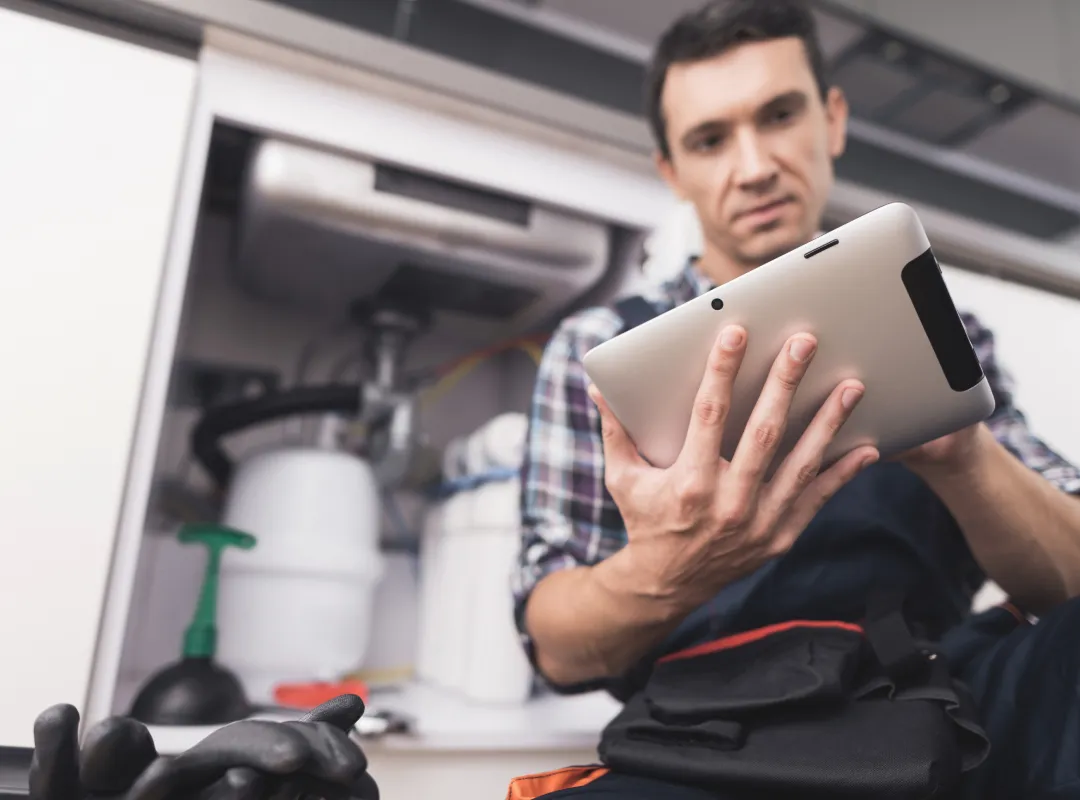 A Trades person using a tablet in a job site - Cloud based facilities management