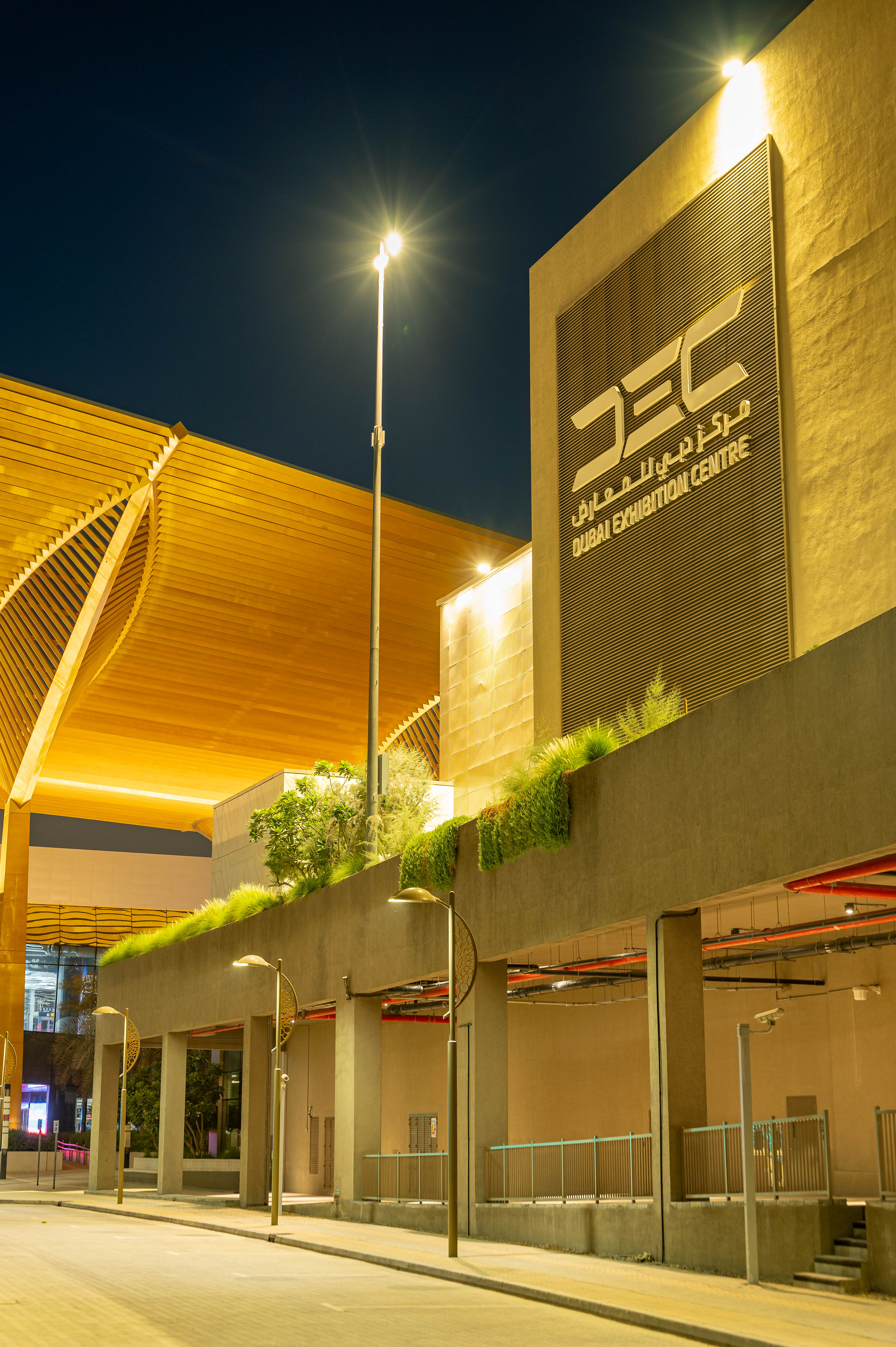 Planted screens mounted between building columns help soften the building edge