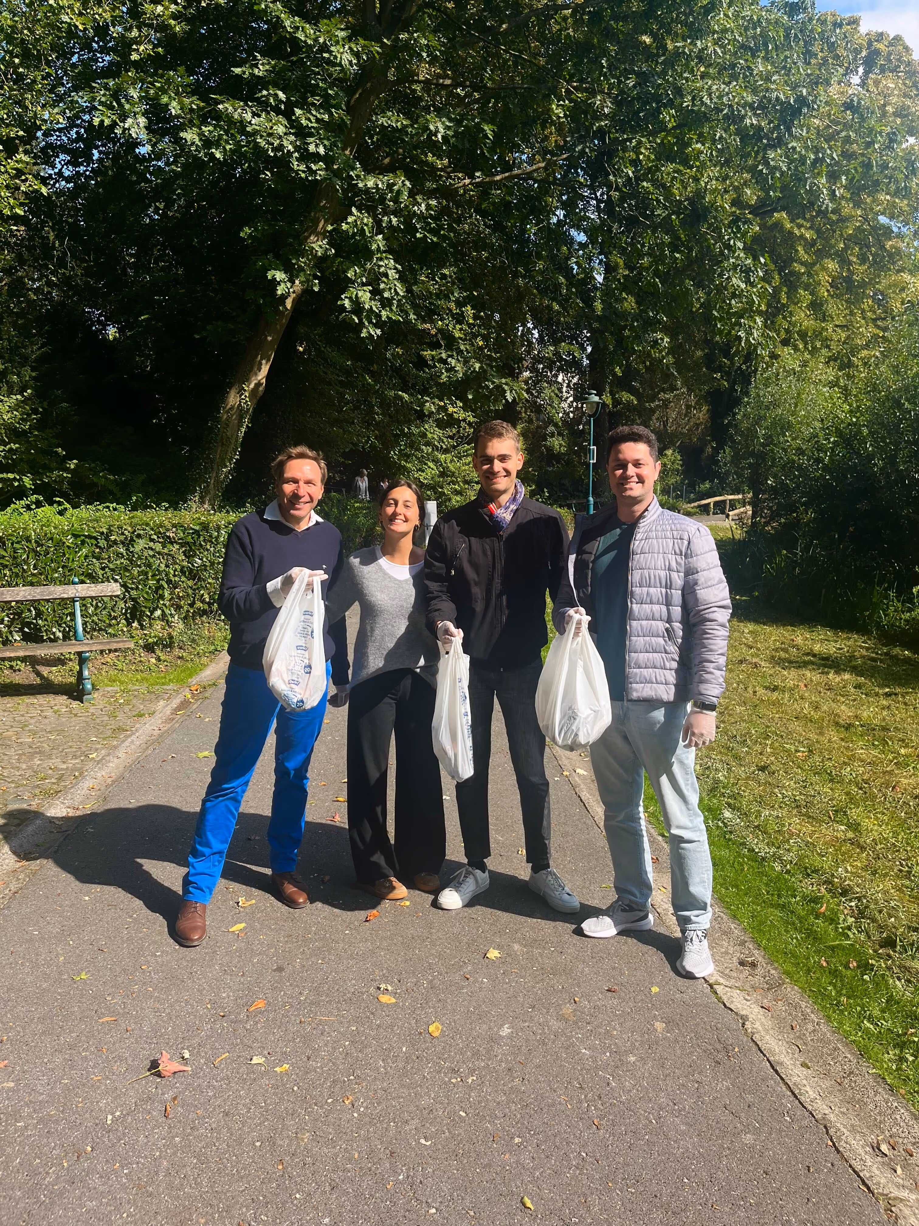 Optimy employees cleaning a park