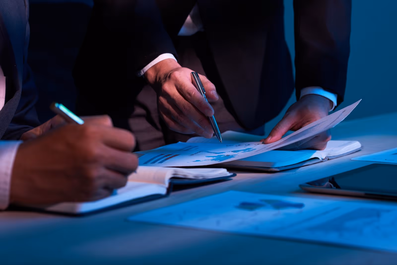 Business professionals reviewing printed reports