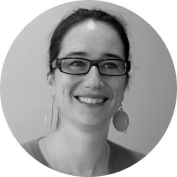 Smiling woman with glasses and large earrings, portrait
