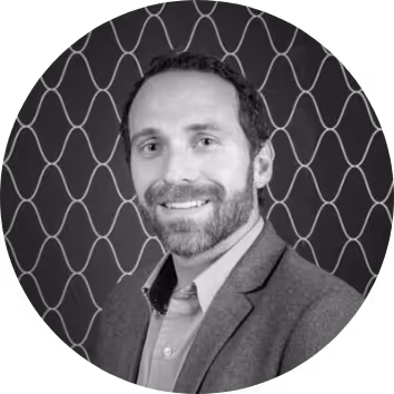 Smiling man with a beard in a suit jacket, portrait