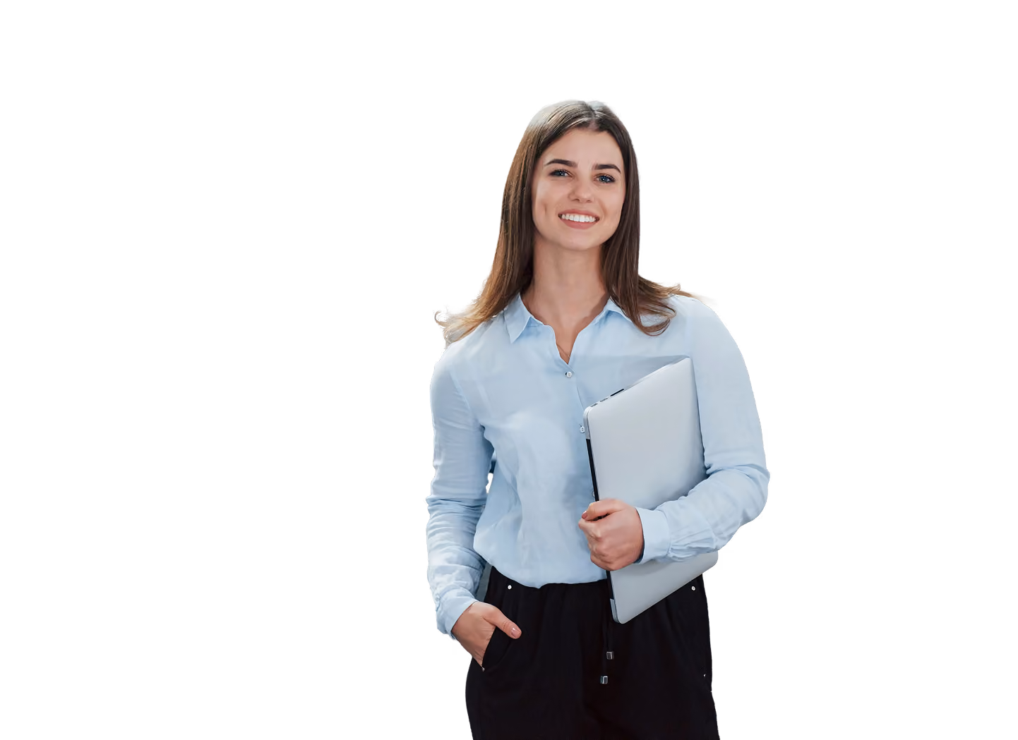 Smiling woman in light blue shirt holding laptop in office with coworkers talking in background.