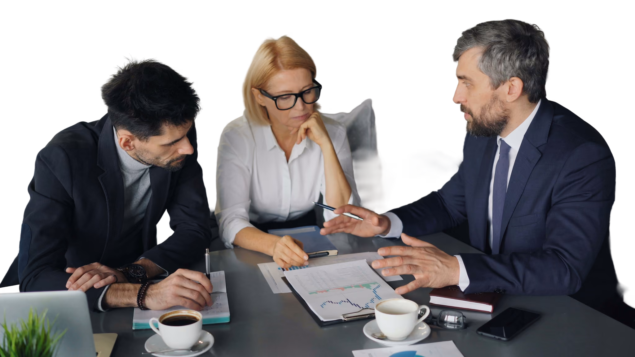 Three business people discussing charts and notes at a table with coffee cups and a laptop.