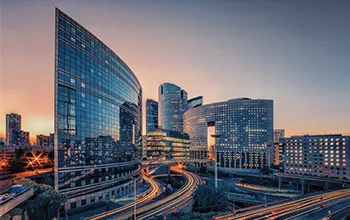 city skyline highlighting a modern building at sunset