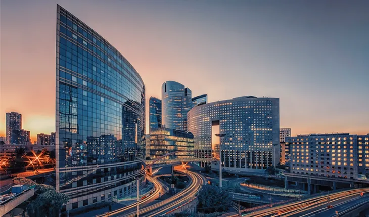 city skyline highlighting a modern building at sunset