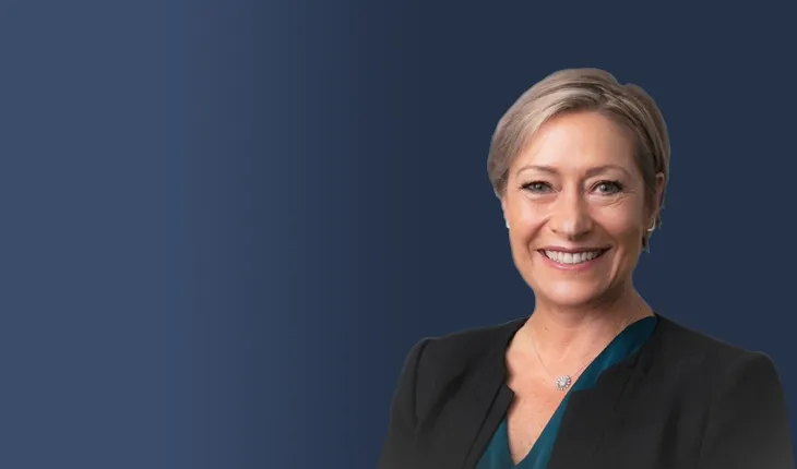 kris greenwood headshot on a dark coloured background