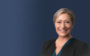 kris greenwood headshot on a dark coloured background