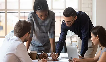 A group of people discuss business strategy with respect to facilities management