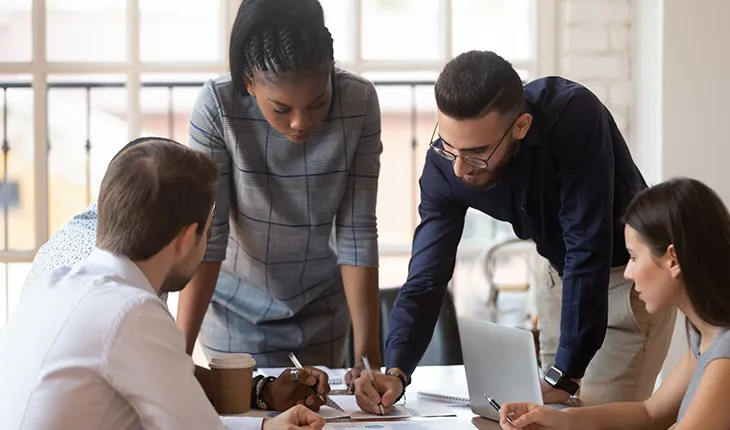 A group of people discuss business strategy with respect to facilities management