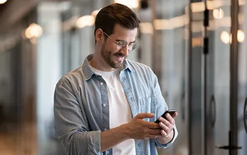 A facility user takes an image of something out of frame to log a maintenance request