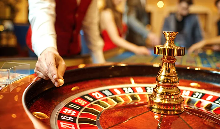 A casino operator spins a roulette wheel 