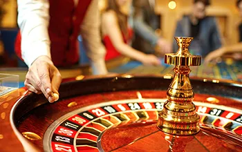 A casino operator spins a roulette wheel 