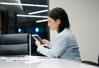 image of a facility manager using a tablet device at a desk