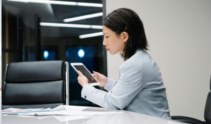 image of a facility manager using a tablet device at a desk