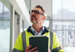 image of a facility manager on site using a tablet device
