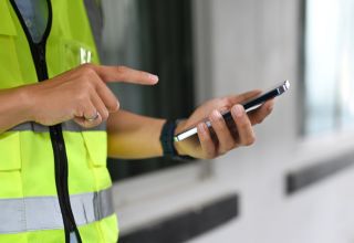 image of a maintenance contractor using a smartphone