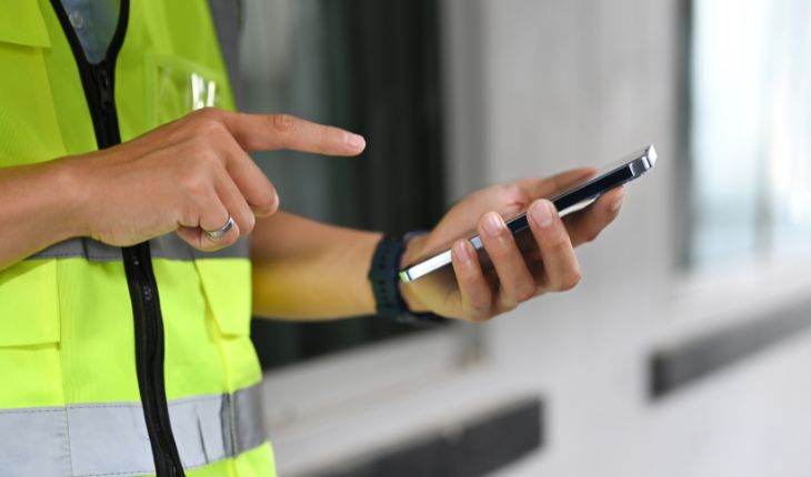 image of a maintenance contractor using a smartphone