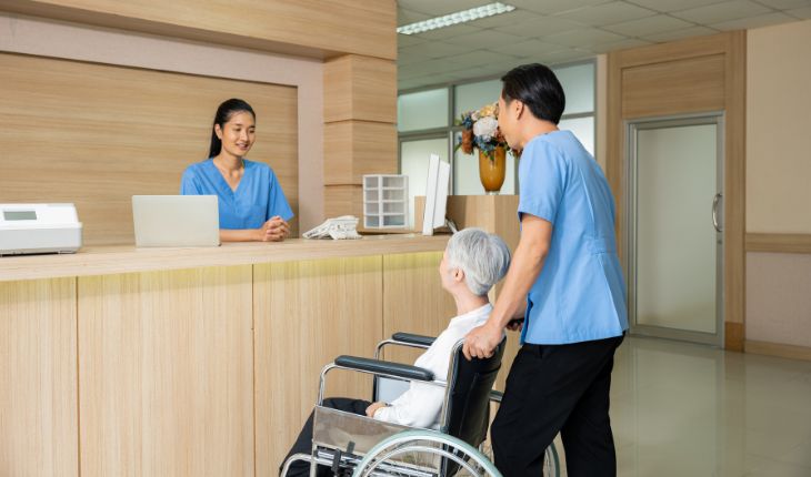 image of aged care staff at a reception area desk, inside an aged care facility