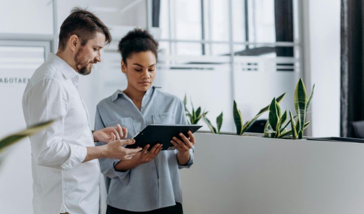 image of two facility managers using a tablet device