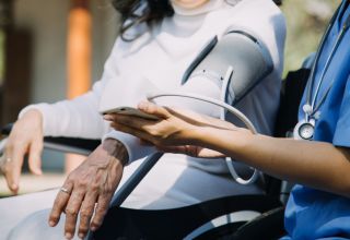 image of an aged care facility worker with a patient