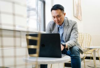 image of a facility manager using a laptop device