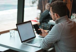 image of a facility asset manager using a laptop device