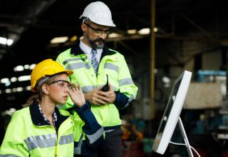 image of two facility managers using a computer