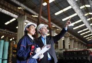 image of two facility staff surveying a site interior