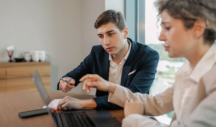 image of two facility managers viewing a laptop device
