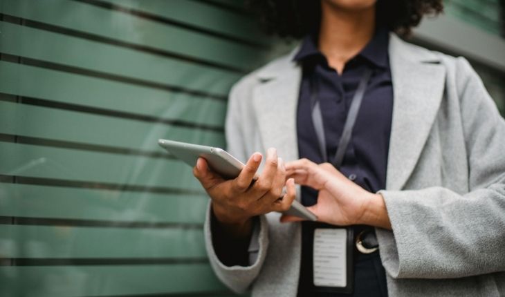 image of a facility manager on site holding a tablet device