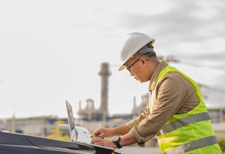 image of a facility site worker using a laptop device