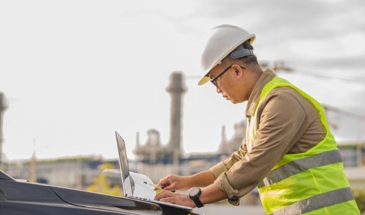 image of a facility site worker using a laptop device