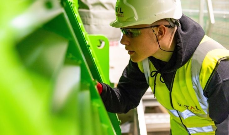 image of a high-vis contractor examining asset equipment