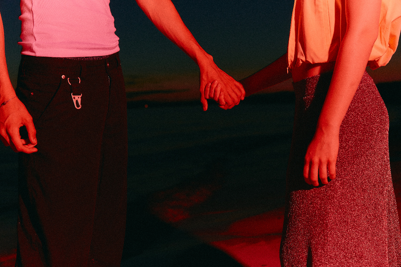 Close-up of two people's hands holding.