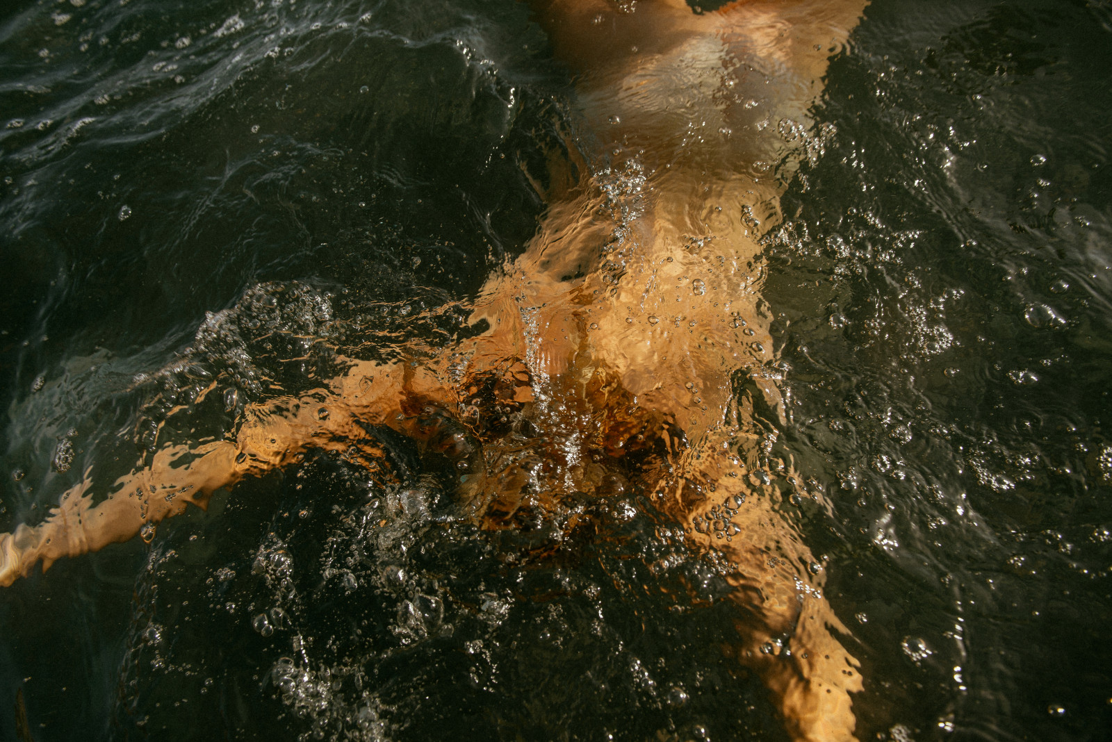 A person swimming underwater. 