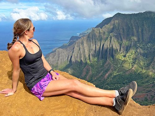 The blogger on a hiking trip, overlooking an amazing coastal view with steep cliffs