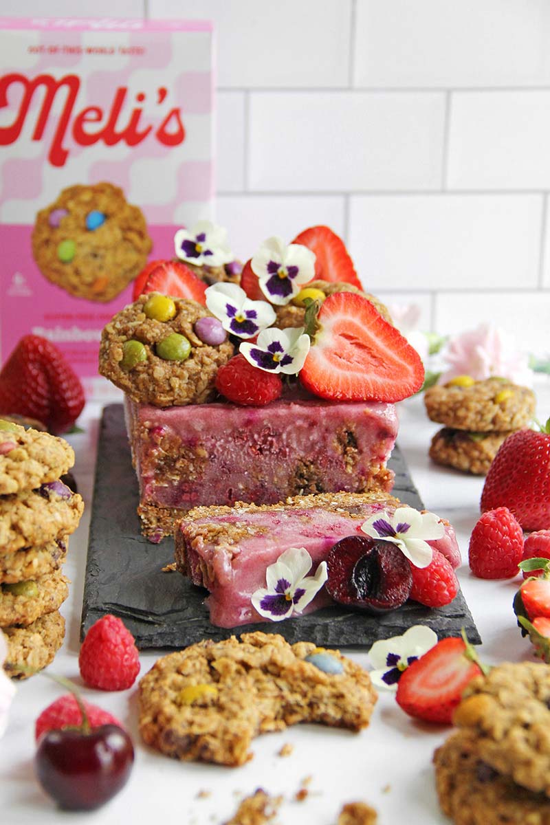 Berry nicecream cake, shown with a bx of healthy cookie mix in the background.