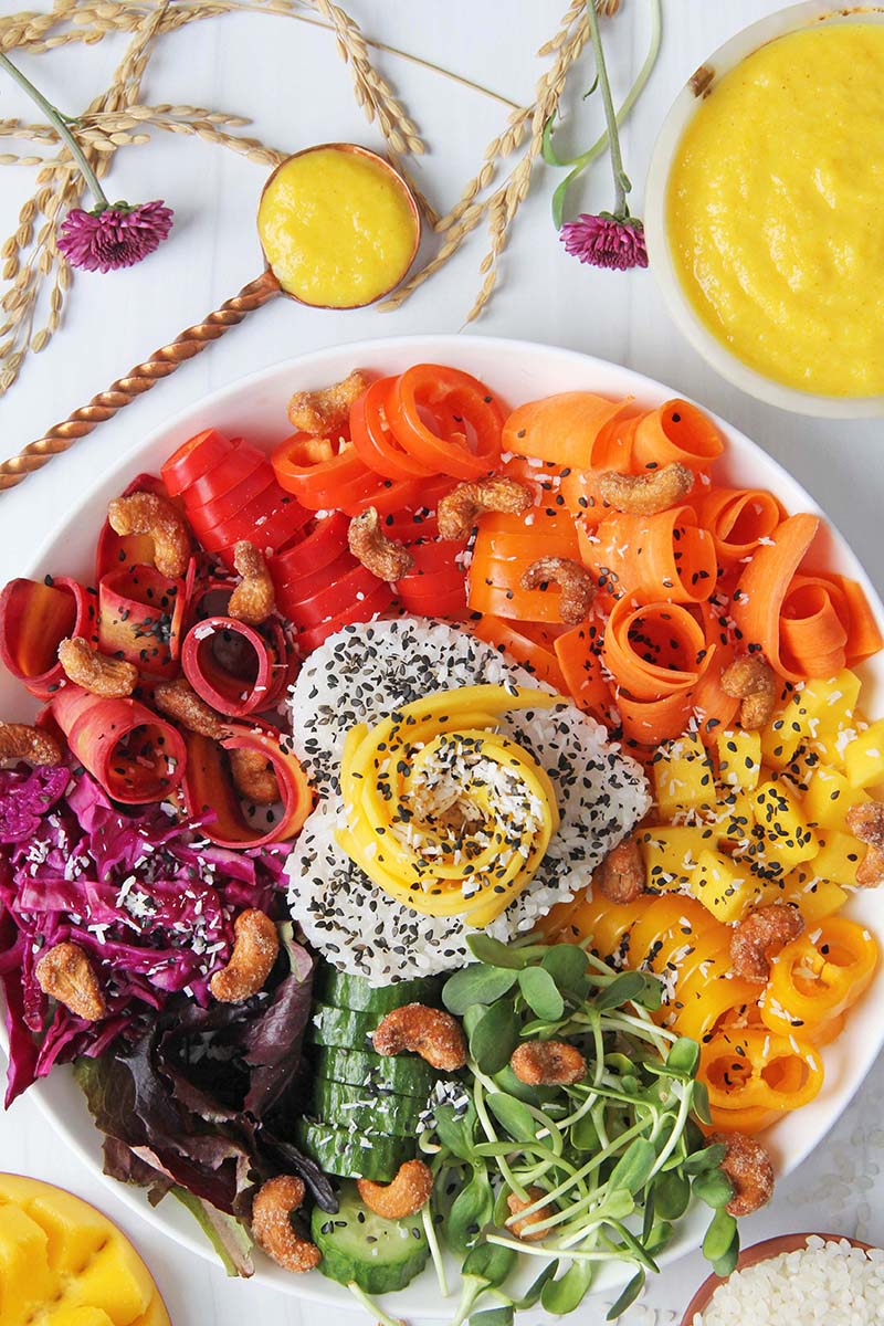 Spicy Mango Rice Bowl, shown with a small serving dish of vibrant yellow spicy mango sauce.