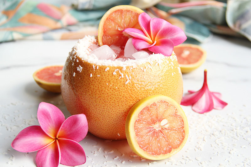 Paloma variation made with coconut rum in addition to tequila, served in a hollowed-out grapefruit, and garnished with grapefruit slices.