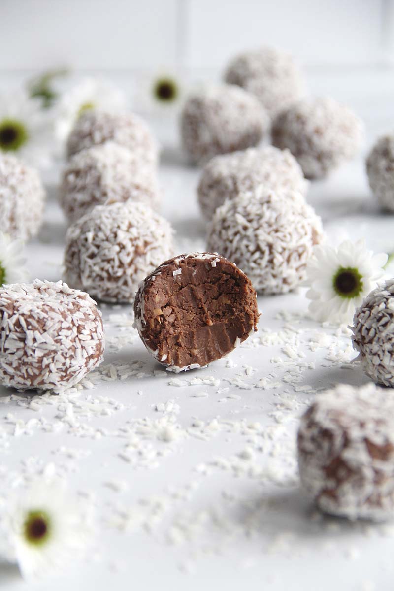 Close-up of a chocolate protein truffle made from chickpeas, showing the rich fudgy center.