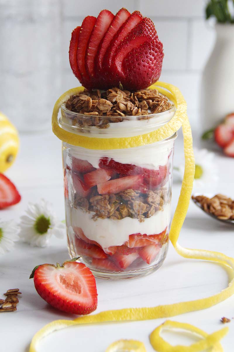 Close-up of a strawberry yogurt parfait, highlighting the layers of creamy yogurt, fresh strawberries, and crunchy granola.