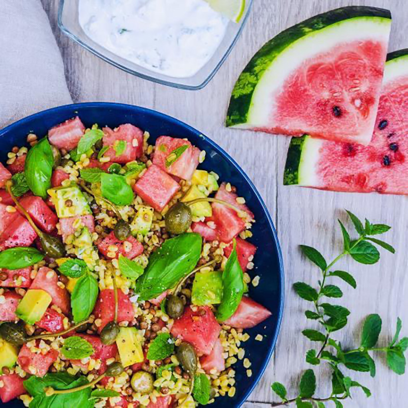 Vegan salad dressing recipe using yogurt as the base, shown on a summer watermelon salad