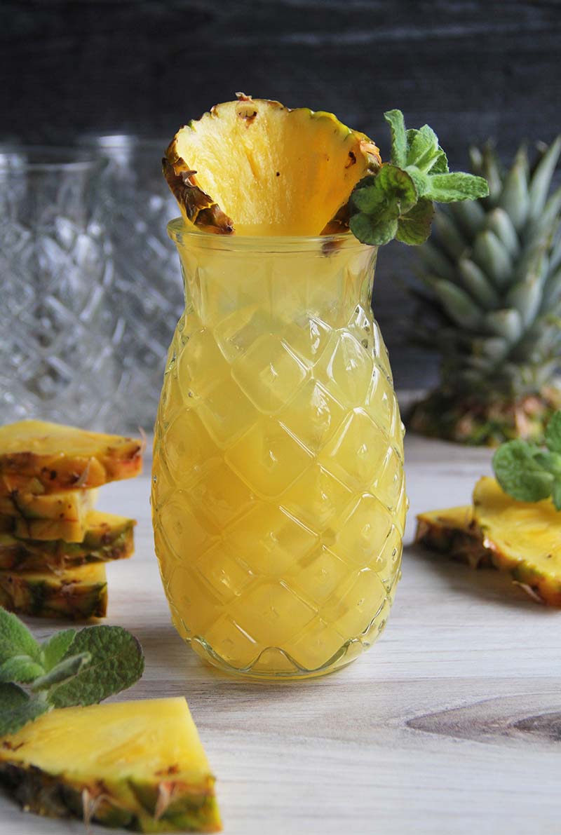 Close-up of a Pineapple Coconut Rum Fizz cocktail in a pineapple-shaped glass.