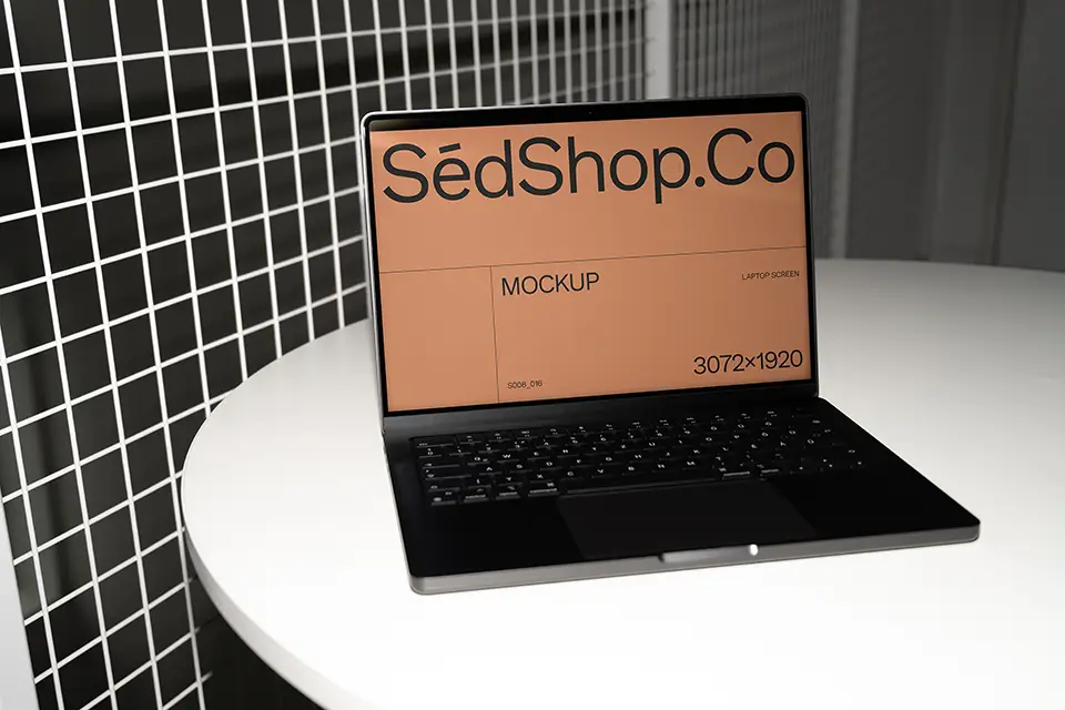 MacBook Mockup on white round table with flash lighting and metal grid background.