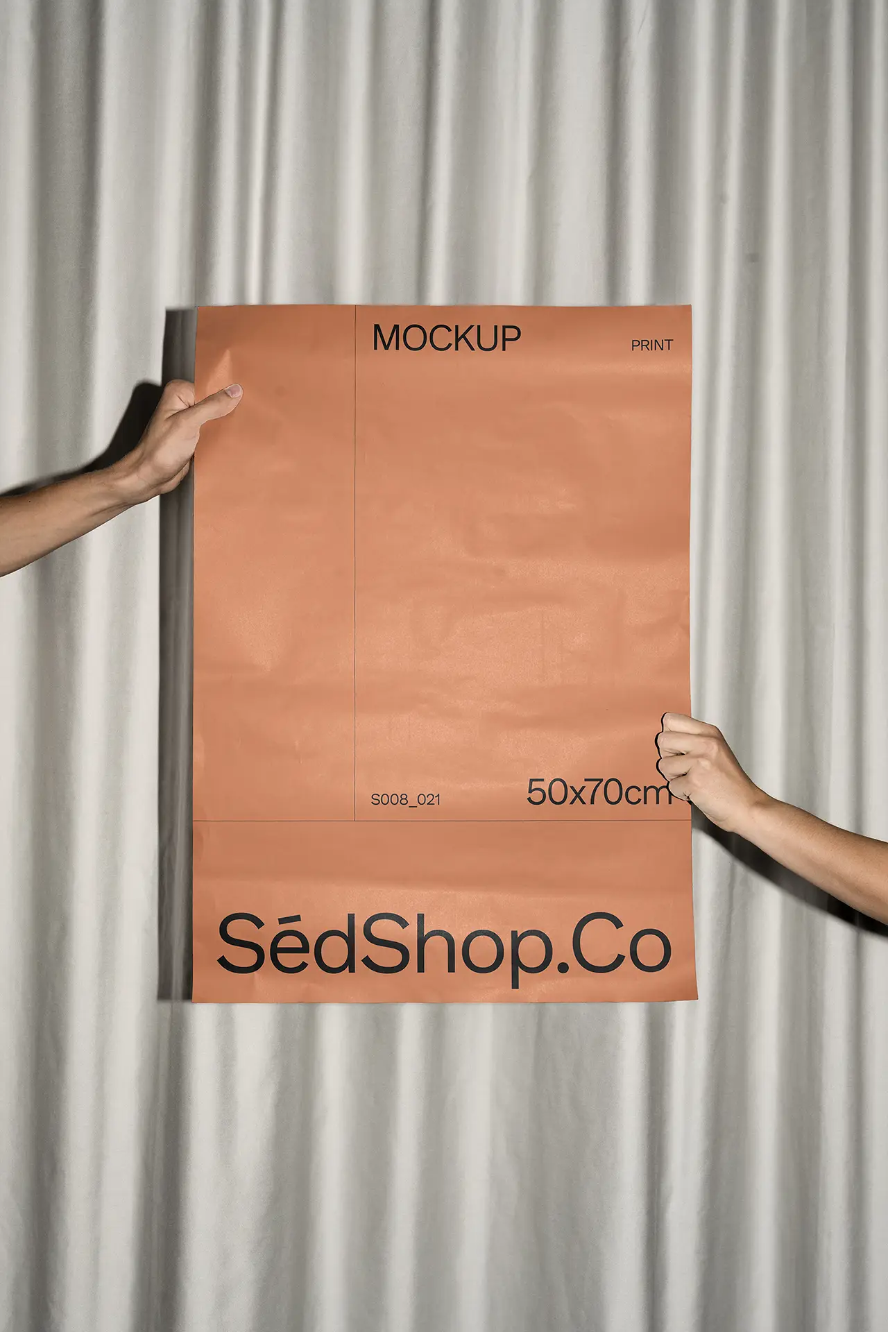 Poster Mockup held by two hands against a curtain background, photographed with flash lighting.