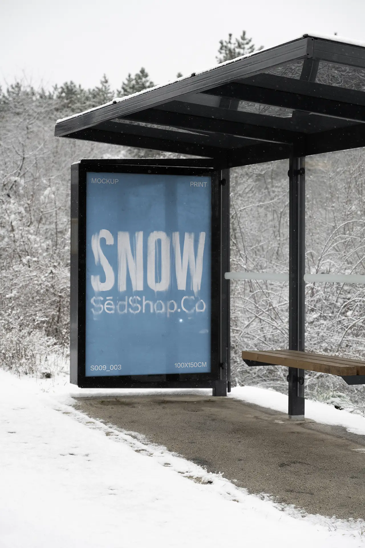 Vertical bus stop poster mockup in a snowy outdoor environment displaying a blue winter design, photographed in soft diffused overcast light.