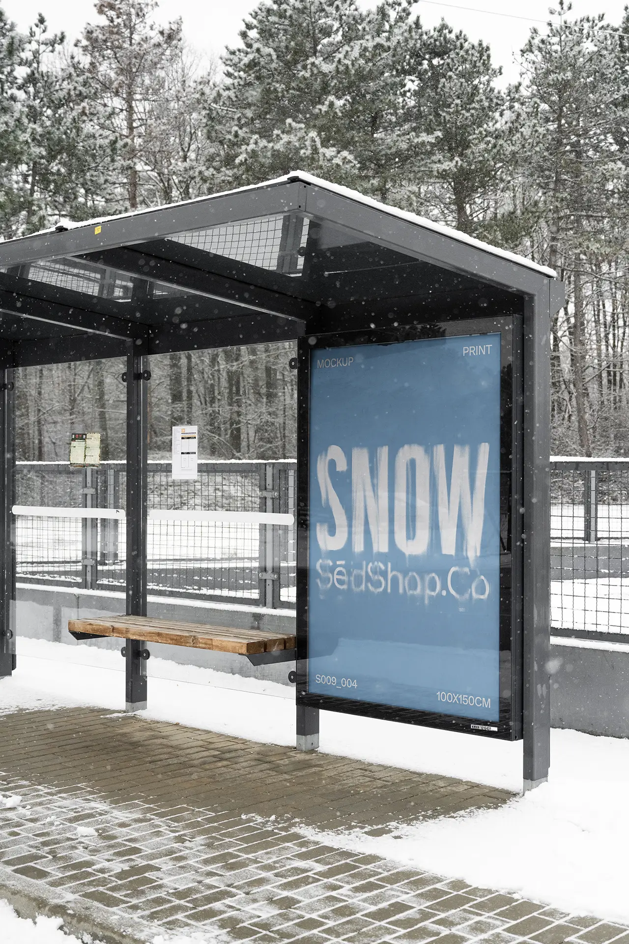Vertical bus stop poster mockup in a snowy outdoor station displaying a blue winter design, photographed in soft diffused overcast light.