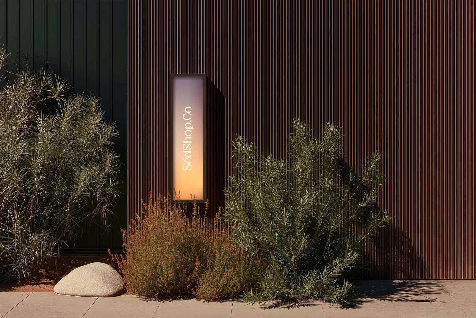 An illuminated citylight screen glowing in an outdoor garden at dusk, showing the SedShop.Co logo.