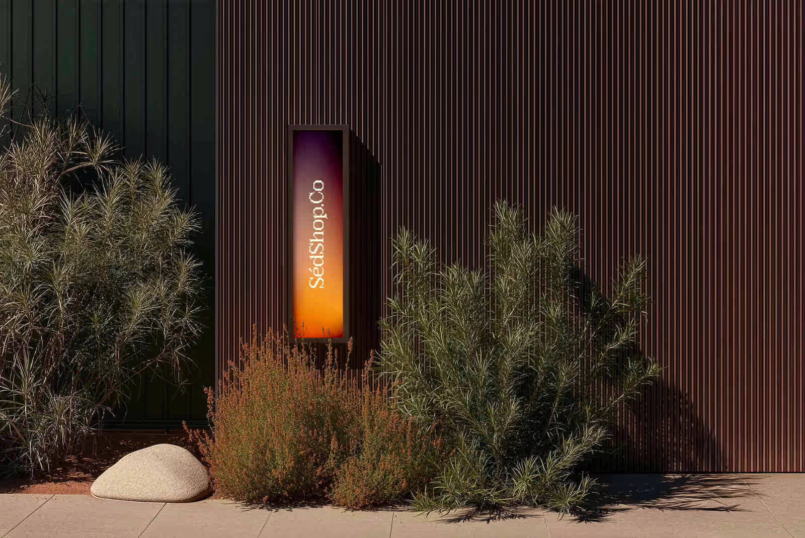 An illuminated citylight screen showing a warm gradient design, glowing in an outdoor garden at dusk.